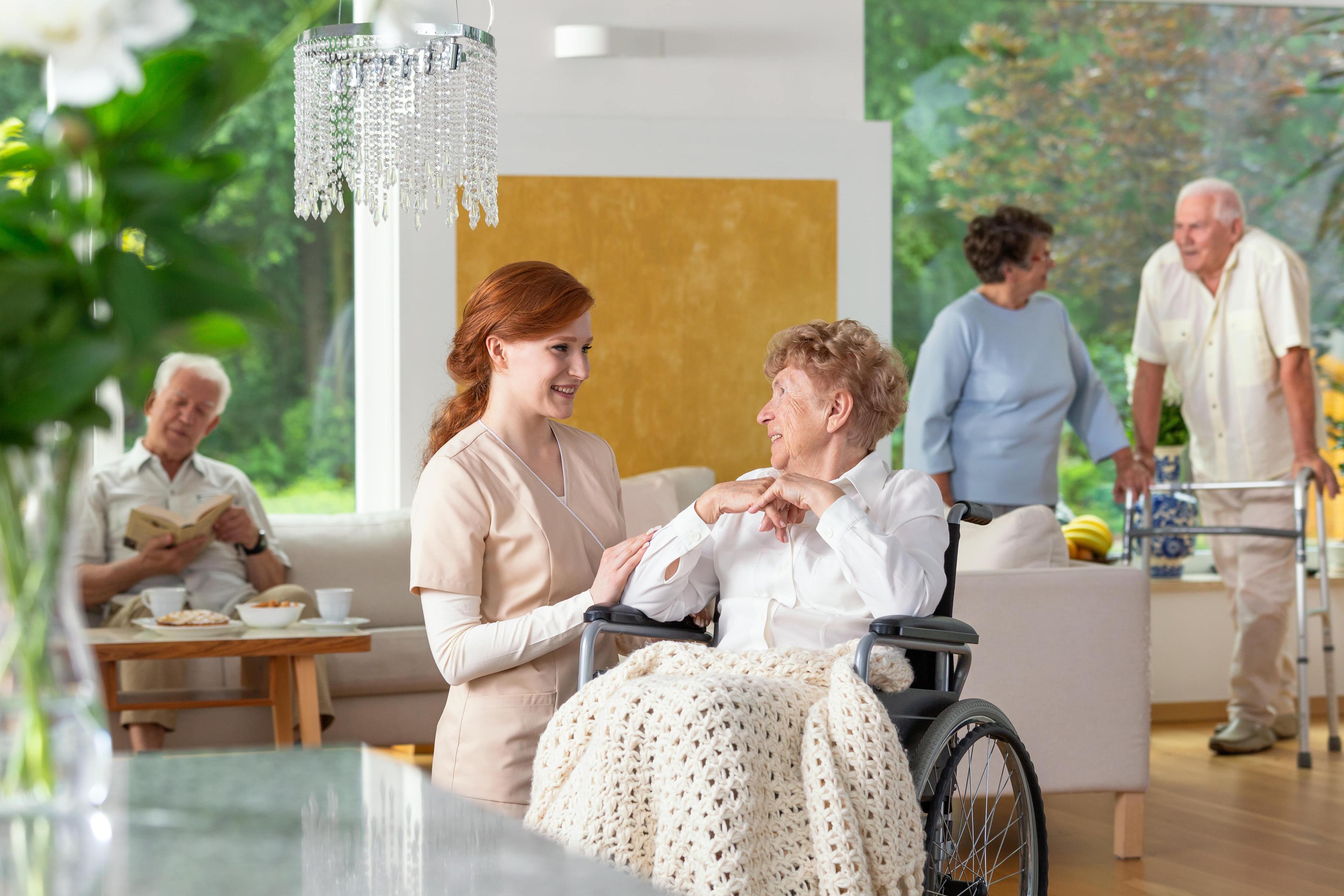 Senior residents enjoying a luxury senior living community while being supported by staff