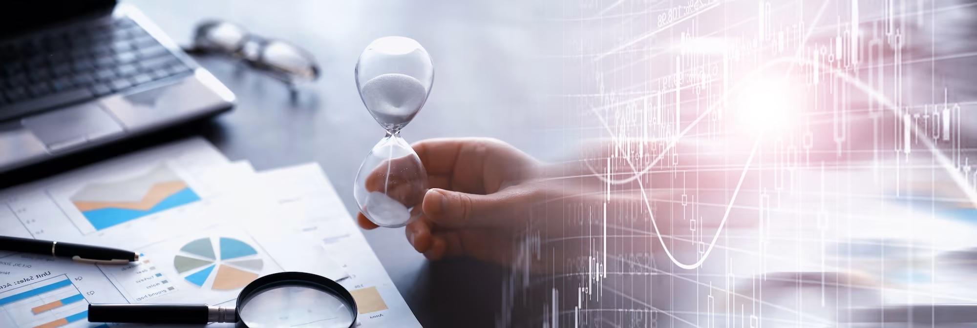 person in office tipping a sandglass keeping time 